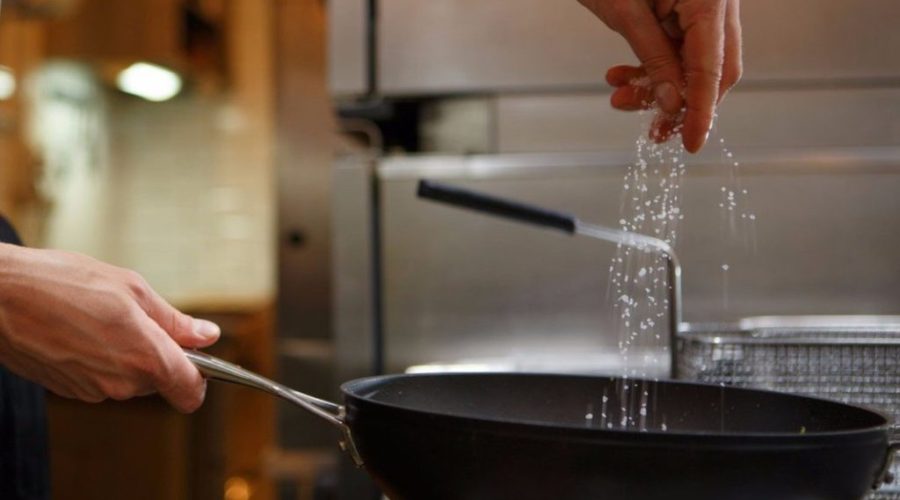 chef adding salt