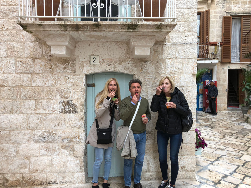 Augusto enjoying a gelato break with guests in Polignano a Mare